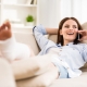 woman with a leg cast lounging on couch and talking on phone